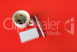 Business cards, coffee cup, pen