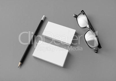 Business cards, pencil, glasses