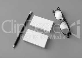 Business cards, pencil, glasses