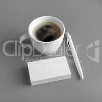 Business cards, coffee cup, pen