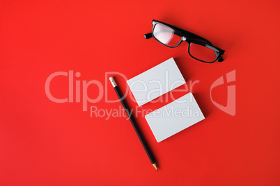 Business cards, pencil and glasses