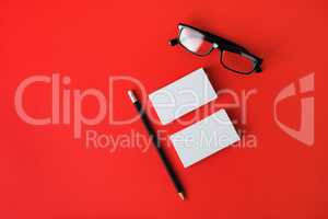 Business cards, pencil and glasses