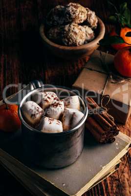 Mug of hot chocolate with tangerines and gingerbread