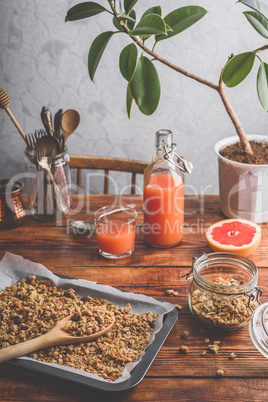 Freshly prepared granola and grapefruit juice for breakfast