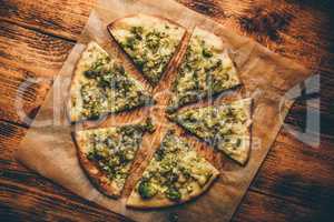Slices of Italian pizza with broccoli, pesto and cheese