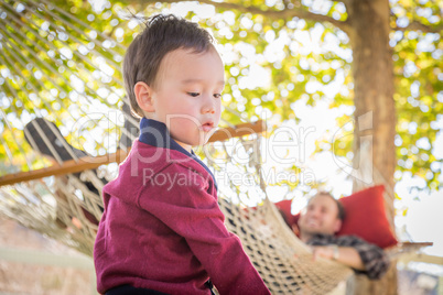 Mixed Race Boy Having Fun Outside While Parent Watches From Behi