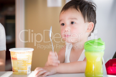 Cute Young Chinese and Caucasian Boy Enjoying Eating His Ice Cre