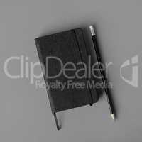 Black notepad, pencil