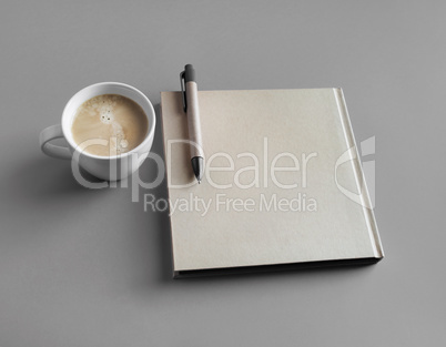 Booklet, coffee, pen
