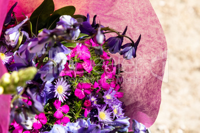 Purple bouquet of delphinium and daisy flowers