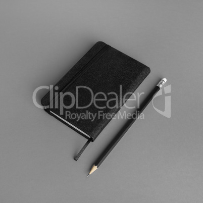 Black notepad, pencil