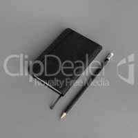 Black notepad, pencil