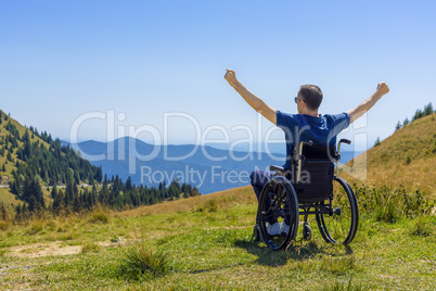 optimistic handicapped man sitting on wheelchair