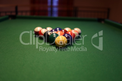 Colored pool balls on a green pool table. Billiard ball with number one