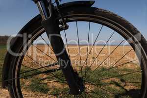 Bicycle wheel close-up on a plowed field