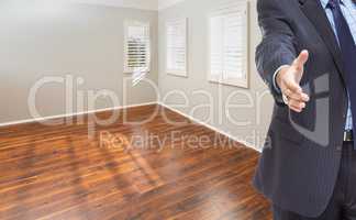 Real Estate Agent Reaches for Handshake Inside Empty Room of New