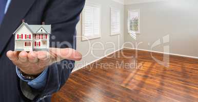 Real Estate Agent Holding Model Home Iside Empty Room of New Hou