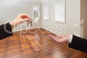 Real Estate Agent Hands Over New House Keys Inside Empty Room