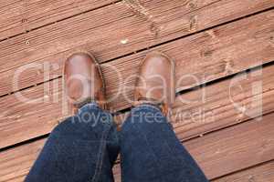 Feet in red shoes on a red wood floor
