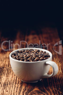 Roasted coffee beans in cup