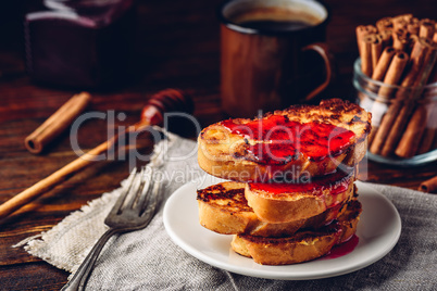 Stack of french toasts with berry syrup