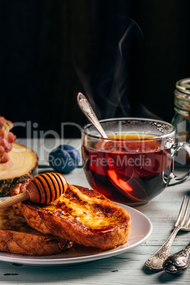 French toasts with honey, fruits and tea