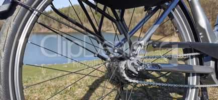 Bicycle wheel close up on the background of the lake