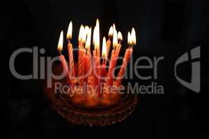 Small cake with candles on a dark background