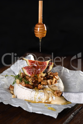 Baked brie cheese with nuts and honey