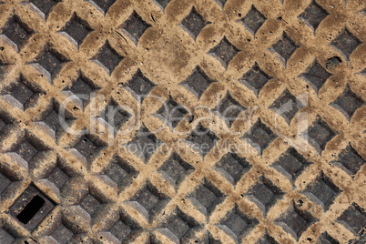 metal cap on the road after rain in close up