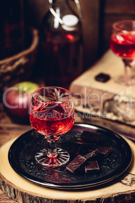 Glass of red liquor with chocolate bars