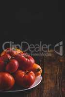 Fresh red and yellow tomatoes on plate