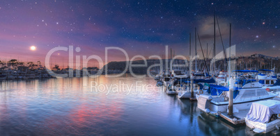 Moon and stars over boats at the harbor of Dana Point