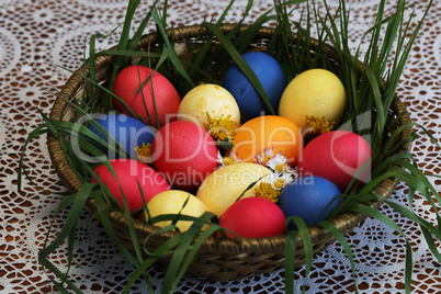 Colorful Easter eggs in a basket made up with flowers