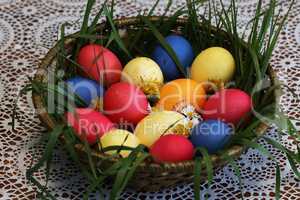 Colorful Easter eggs in a basket made up with flowers