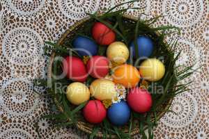 Colorful Easter eggs in a basket made up with flowers