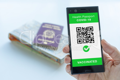 Digital Health Passport app for smartphone with vaccinated sign and quad code.