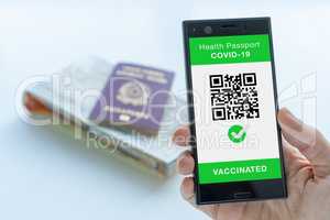 Digital Health Passport app for smartphone with vaccinated sign and quad code.