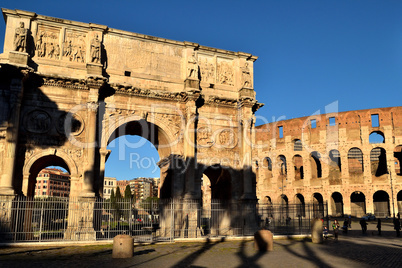 Rome, Italy - December 13th 2020: View of the Arch of Constantine and Coliseum with few tourists due to the Covid19 epidemic