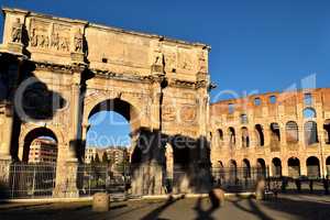 Rome, Italy - December 13th 2020: View of the Arch of Constantine and Coliseum with few tourists due to the Covid19 epidemic