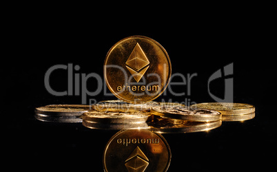 Closeup golden coin with Ether logo. New cryptocurrency Ethereum ETH 2.0 on a top of bitcoin coins against black background. A heap of decentralized digital currency. Crypto payment. Electronic money