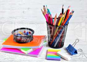 Color pads and colored pencils in a container, eraser and paper