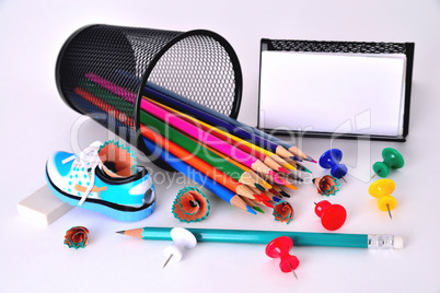 Color pencils, pencil sharpener, business card holder, eraser on