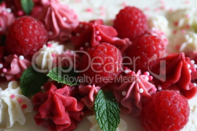 Birthday cake with cream and fresh raspberries