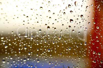 Background of a drop on the glass with colored stripes
