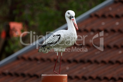 Plastic stork serves as a decoration in the garden