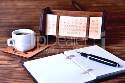 Notebook coffee cup and calendar