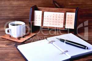 Notebook coffee cup and calendar