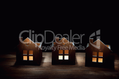 Three wooden candlesticks on a wooden background