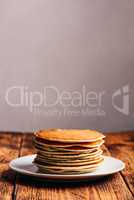 Stack of american pancakes on white plate